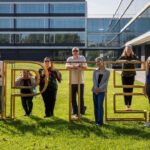 Team posing with “UPTEC” sign