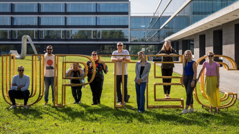 Team posing with “UPTEC” sign