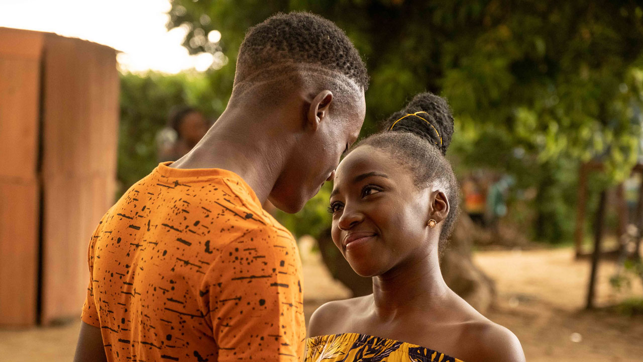 Young man and woman facing each other and smiling at each other