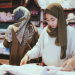 Indonesian female selecting fabrics for cloth designing
