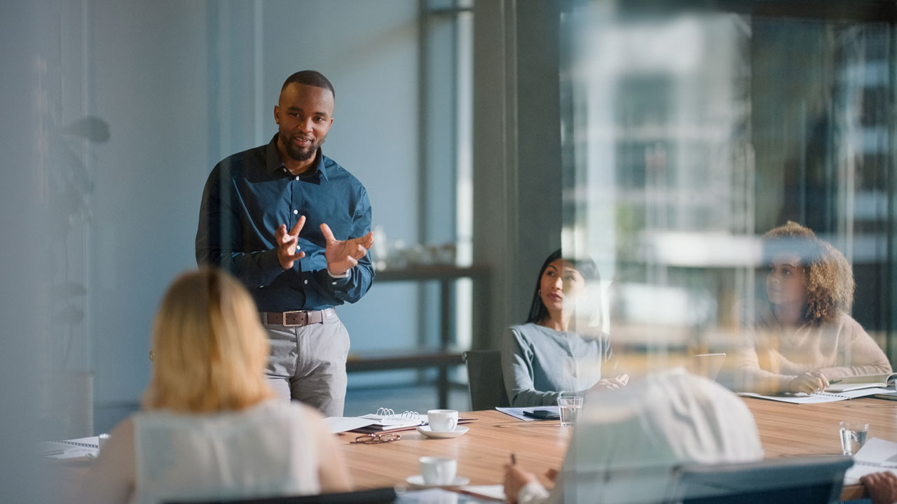 A business professional leading a discussion in a boardroom meeting
