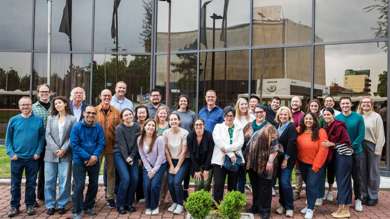 Group of Kaizen professionals posing for a group photo in front of a building